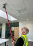 A photo of a team member testing a smoke alarm